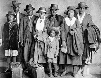 file:/activities/oralhistory/cappics/loving1914_migration, alt: family of eight with suitcases