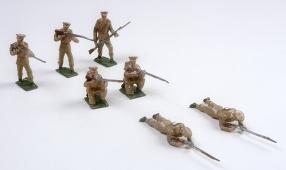 group of seven toy soldiers in various positions of fighting