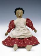 home-made cloth doll with red dress and white apron