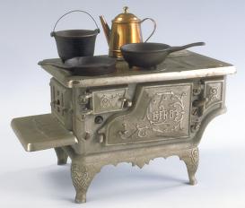 miniature metal cookstove with pots and pans